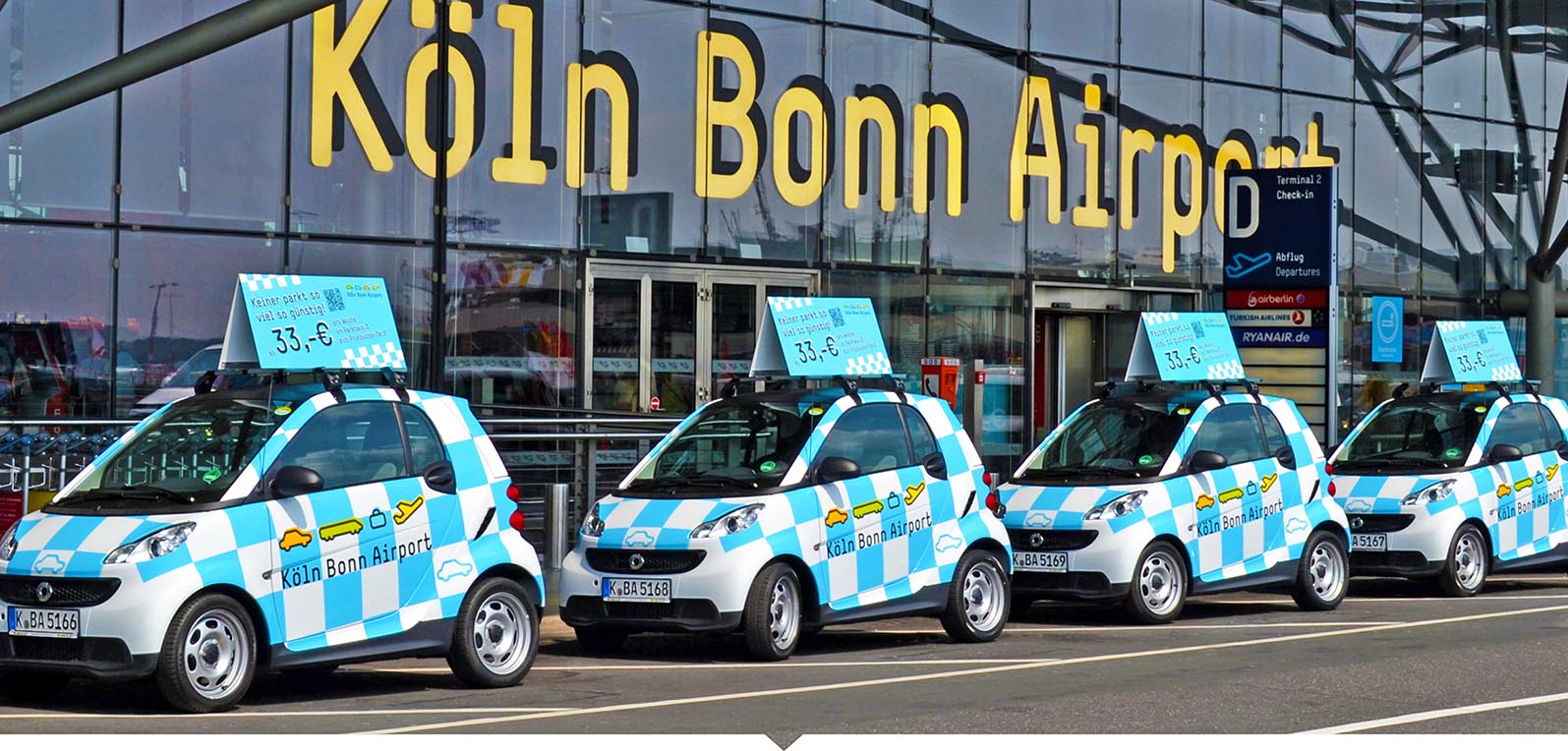 Promotion vom Flughafen K&#246;lnBonn, Flottenvollverklebung inkl. Dachaufbauten mit Direktdruck und Montage